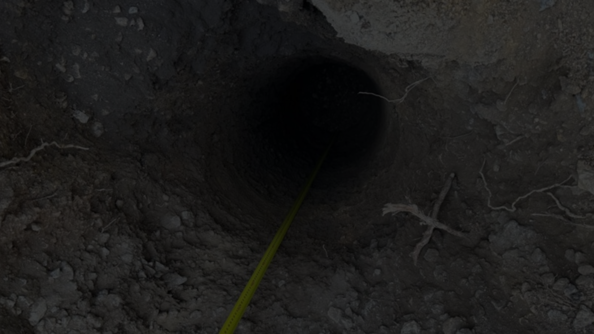 Retaining Wall Engineers Brisbane – retaining wall footing bore hole with depth measurement.