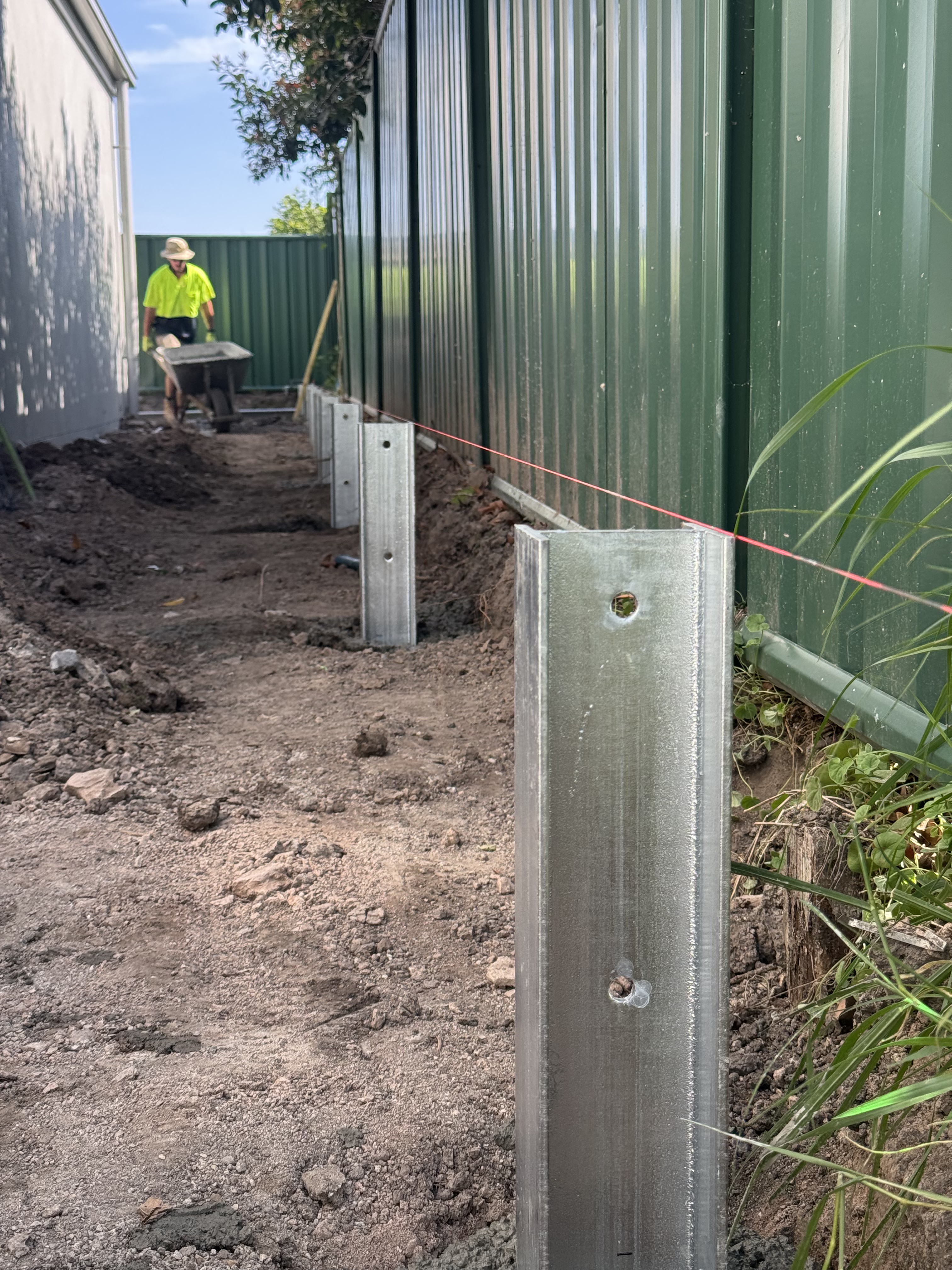 Steel post installation for engineered retaining wall in Brisbane